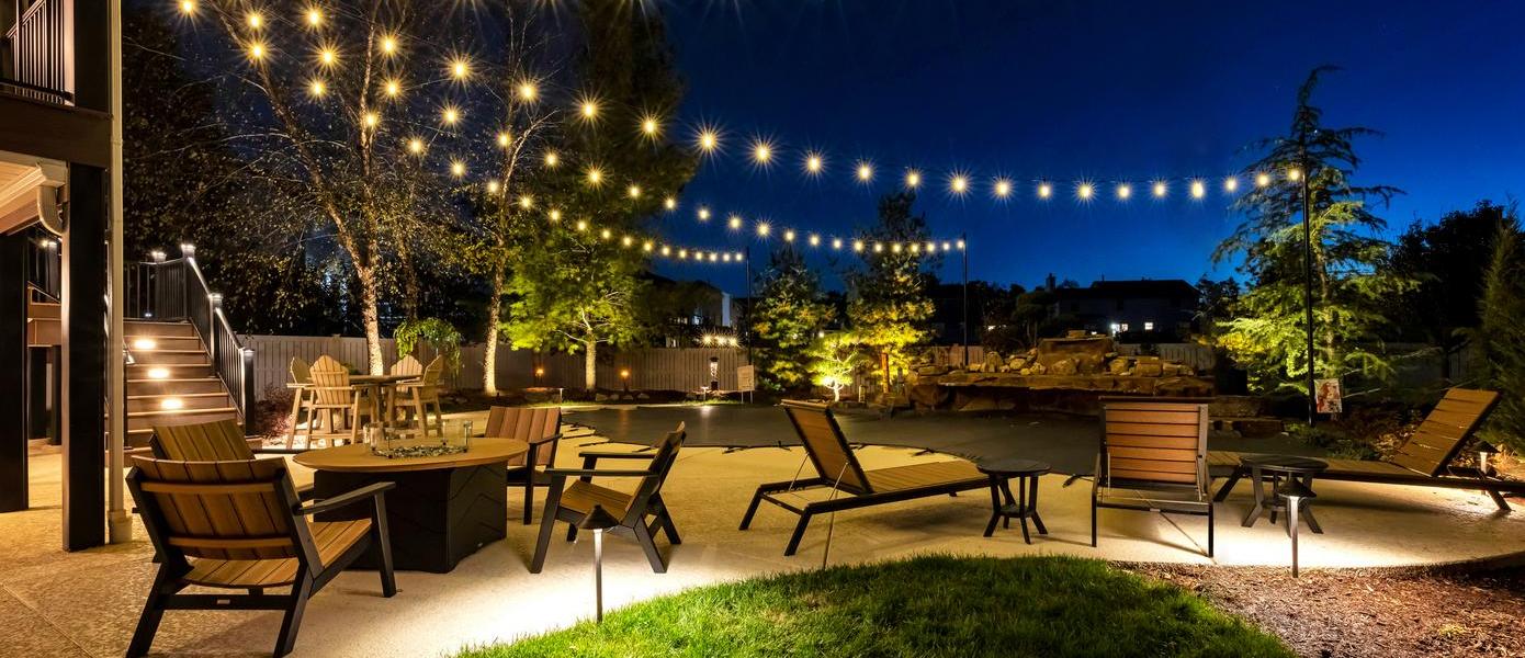 pool and patio covered by string lights