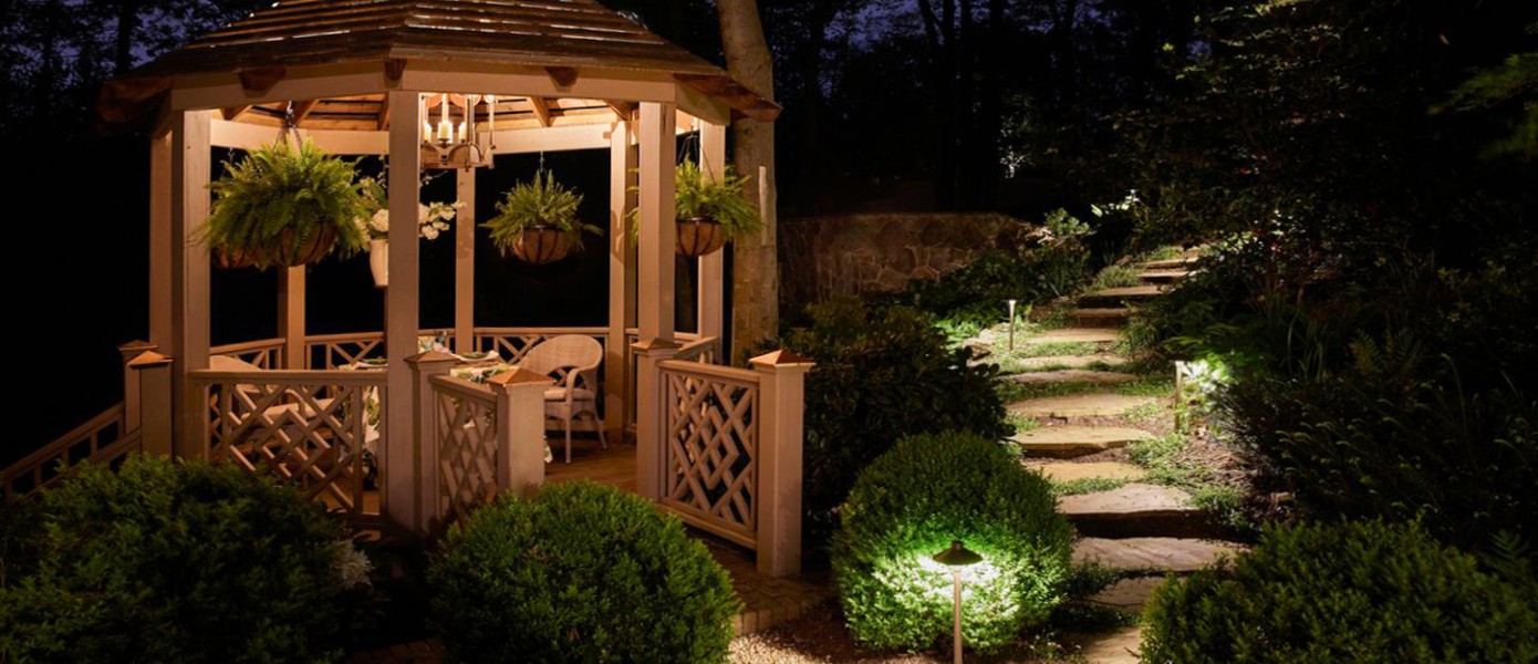 gazebo with steps leading up to with outdoor lighting and a lot of plants