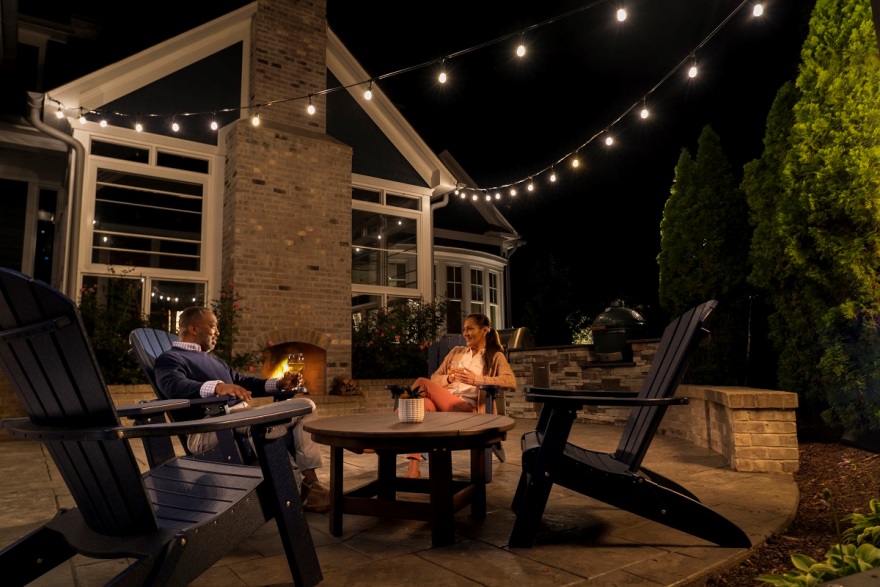 people sitting on outdoor furniture with overhead lighting