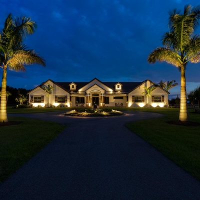 Curb appeal lighting and landscape lighting in Lakewood Ranch, FL welcomes guests after dark. Photo