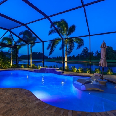 Landscape lighting and deck lighting adds ambiance to this lanai in Sarasota, FL Photo