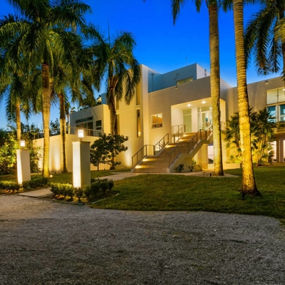 Add curb appeal lighting to your modern home to transform the property after dark in Key Biscayne.   Photo
