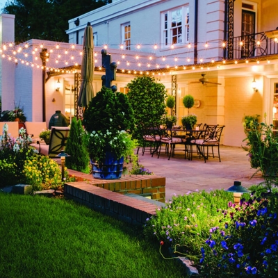 Bistro lighting allows you to entertain friends and family after dark in your backyard.  Photo