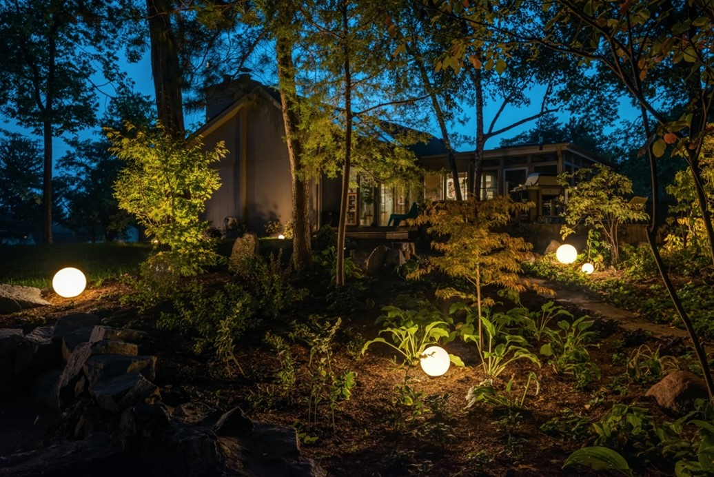 Backyard setting with sphere lighting hanging from trees