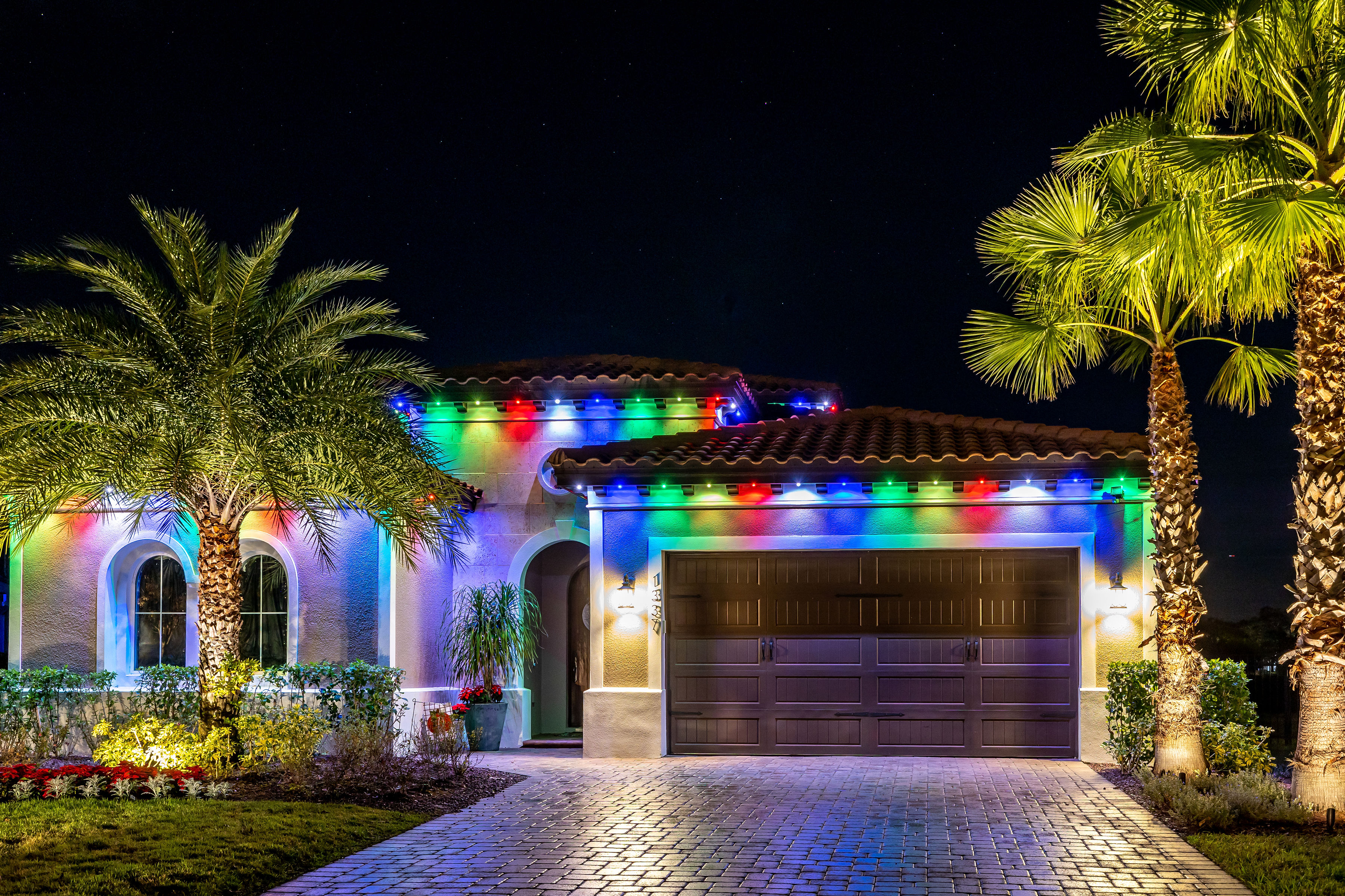 Multicolored permanent roofline lighting on a home