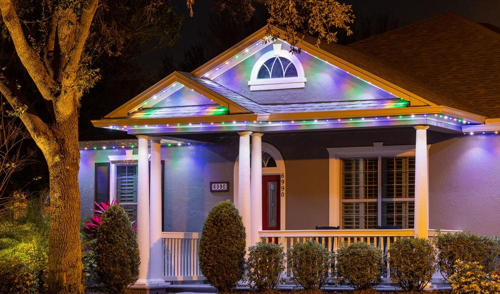 Multicolored permanent roofline lighting on home