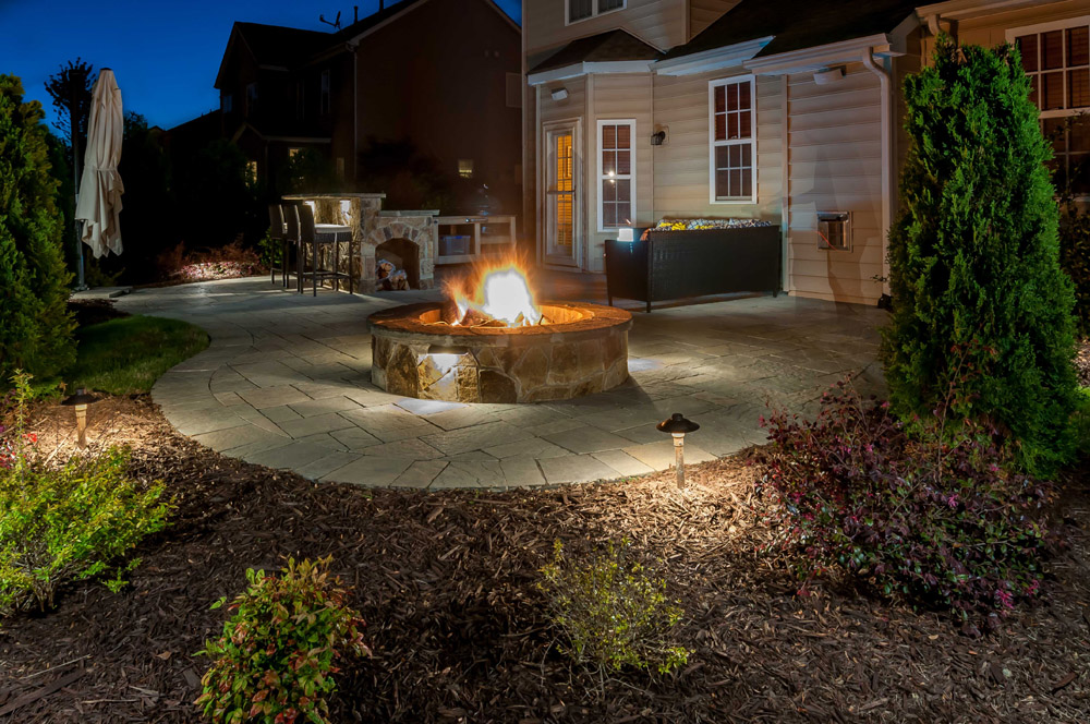 Backyard with firepit lighting