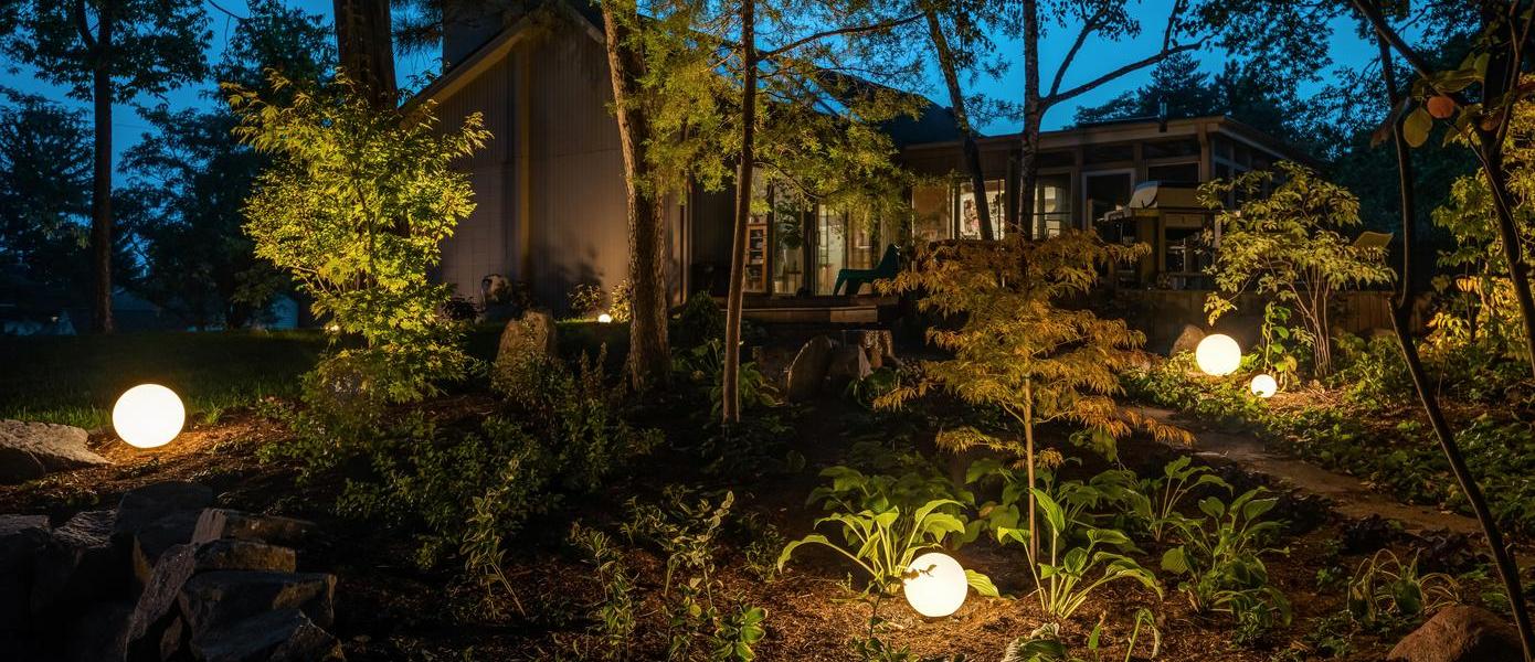Globe lights featured in backyard landscape