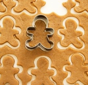 gingerbread cookies being cut out 