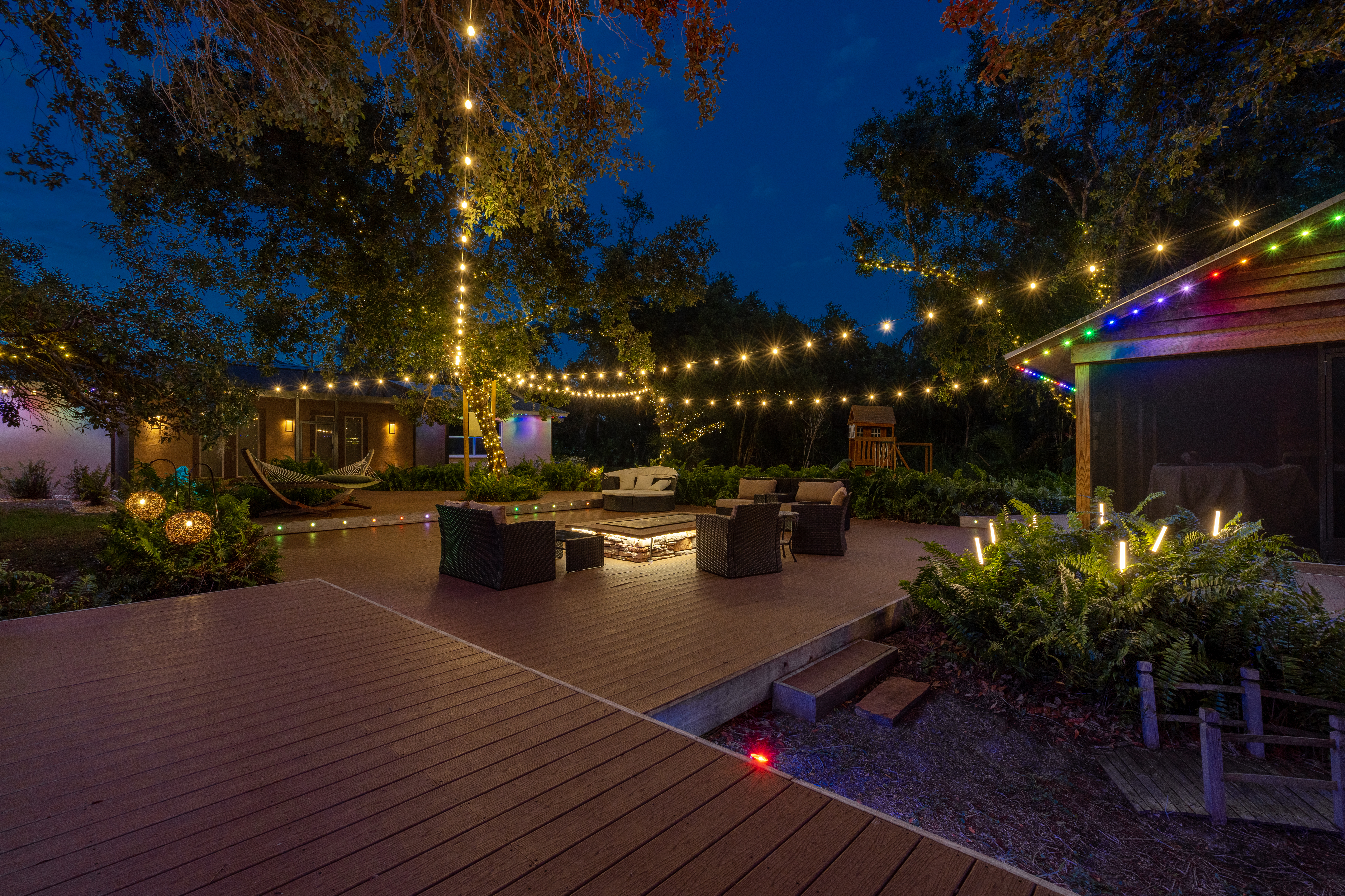 colorful festive string lighting over large outdoor patio in long island