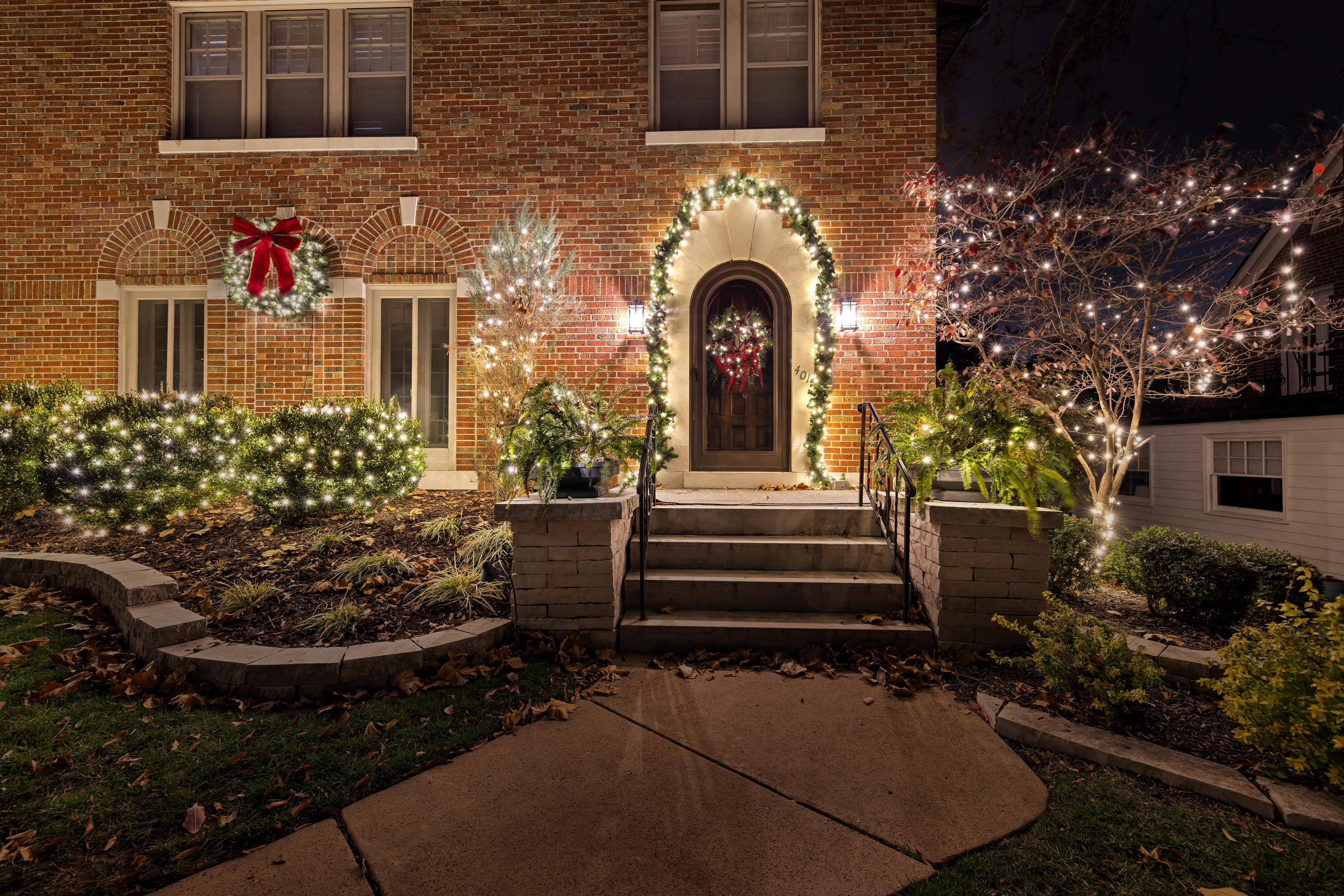 brick house with christmas lights