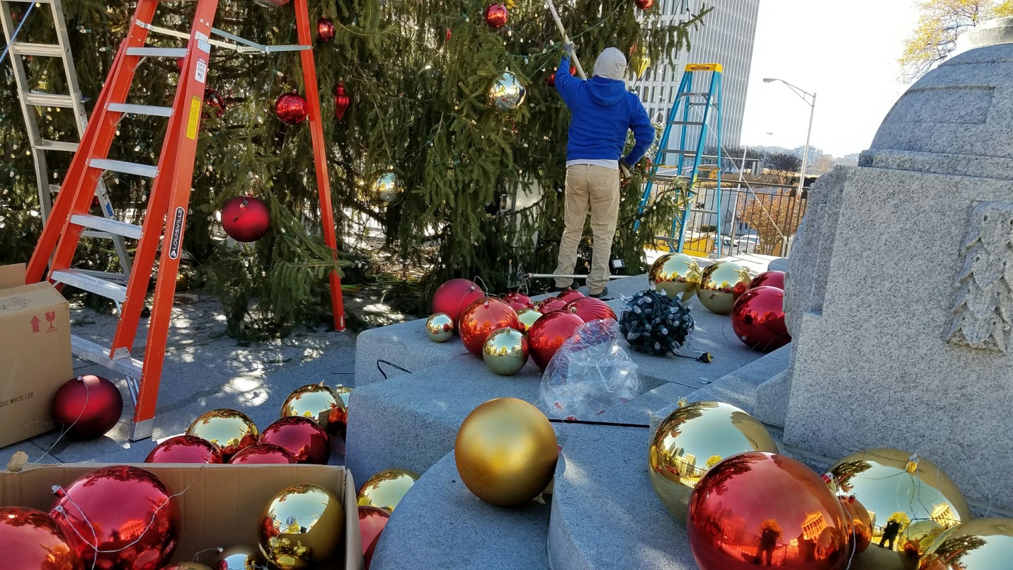 adding ornaments to tree