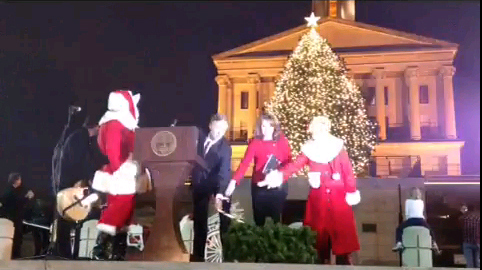 Santa and others by Christmas Tree