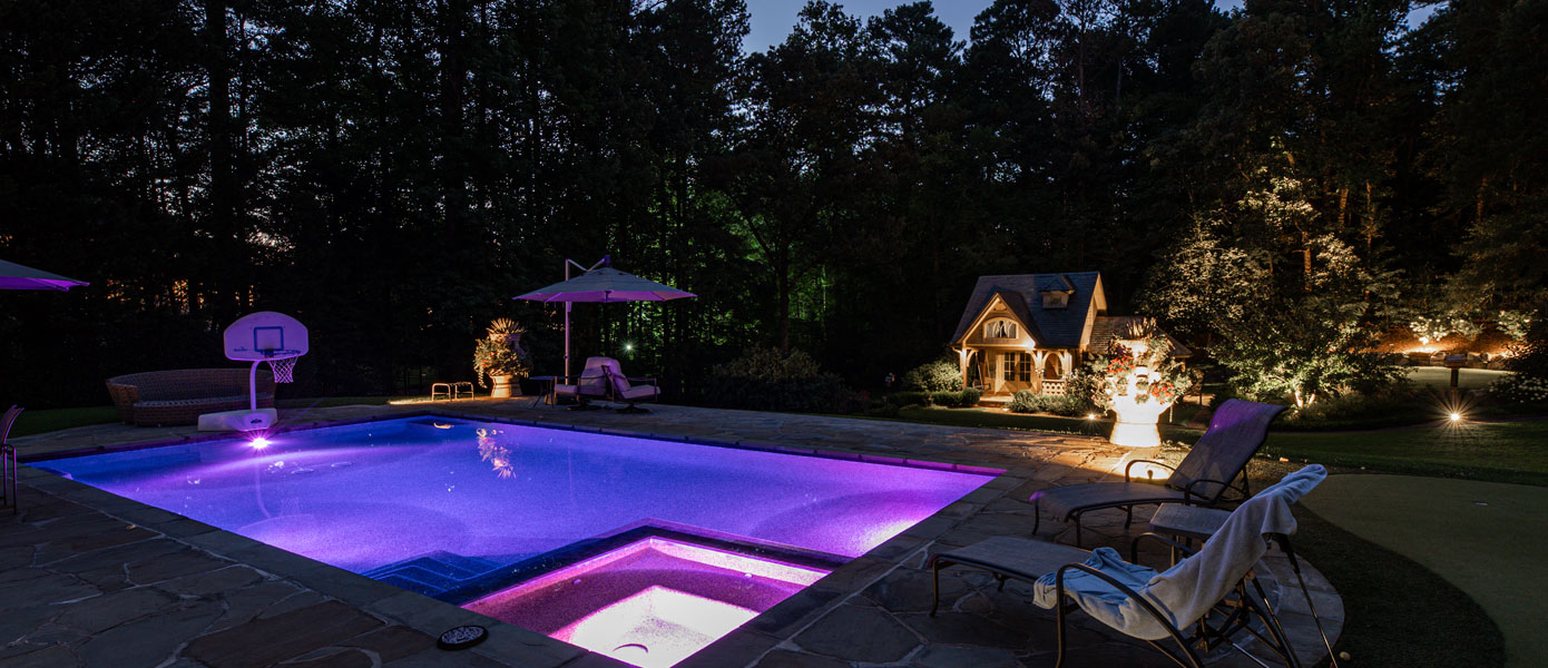 A pool with purple lights at nightDescription automatically generated