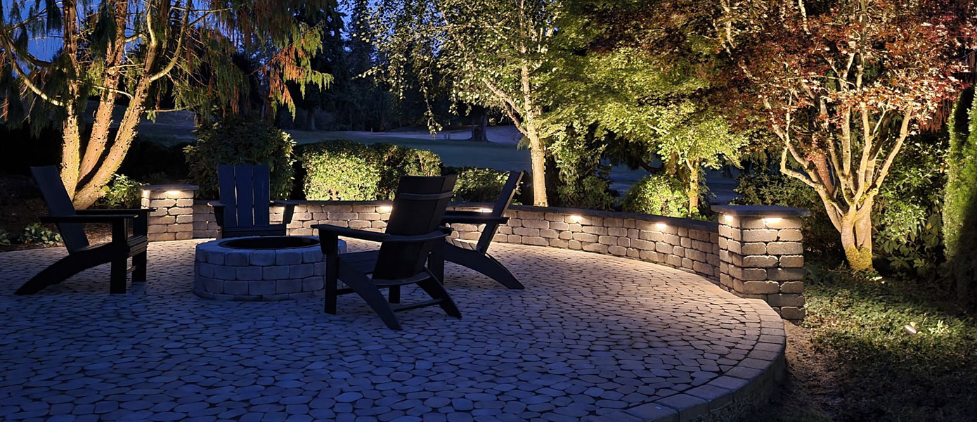 chairs around a fire pit with external lighting