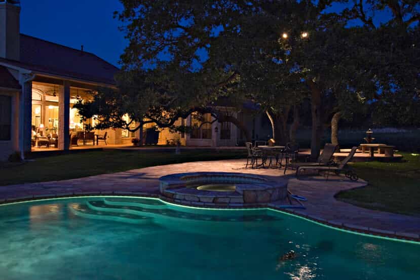 Outdoor pool at night with professional lighting