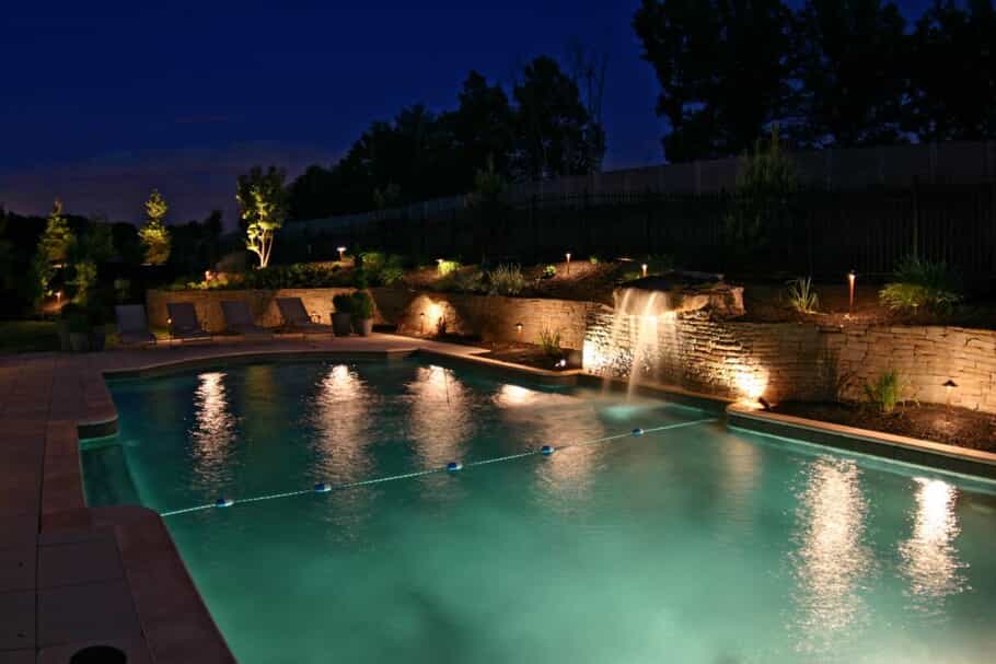 Outdoor pool and water feature with professional lighting