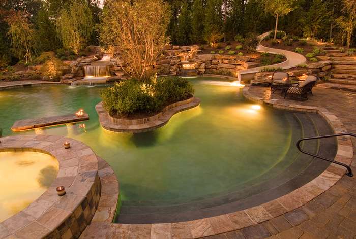 Pool with waterfalls, plants and outdoor lighting