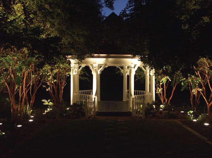 Gazebo with surrounding trees and outdoor lighting