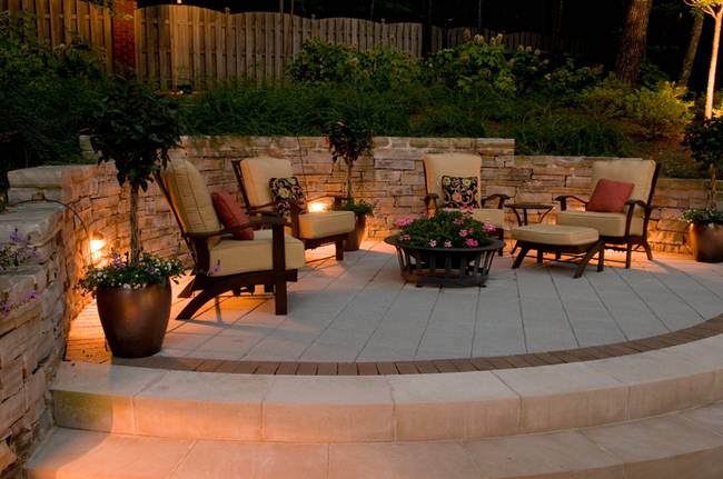 Patio with chairs, plants and outdoor lighting