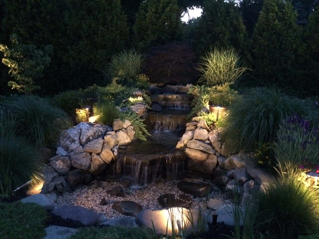 nassau garden waterfall lit by outdoor lighting