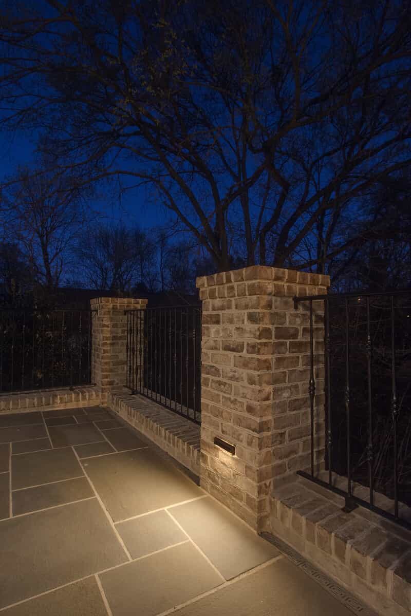 brick pillar lit with outdoor lighting