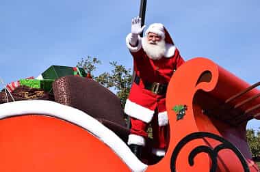 Santa riding on a sleigh in a parade
