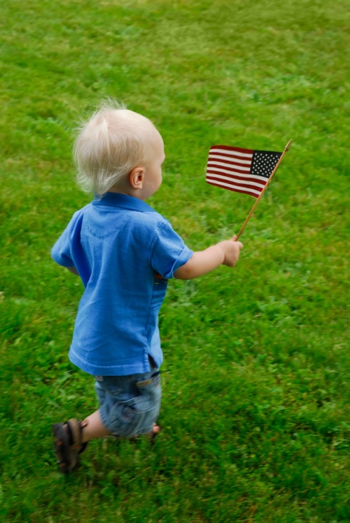 child running with american flag