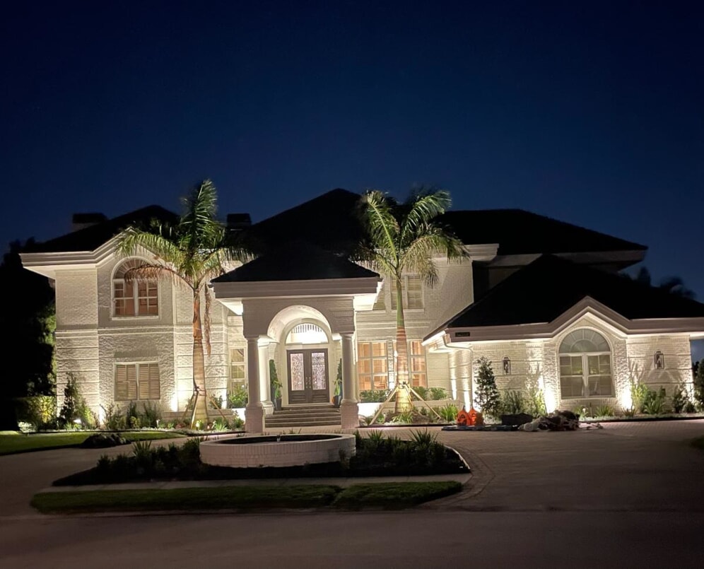 large white home with professional outdoor lighting