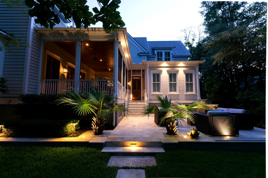 backyard and house and surrounding plants illuminated