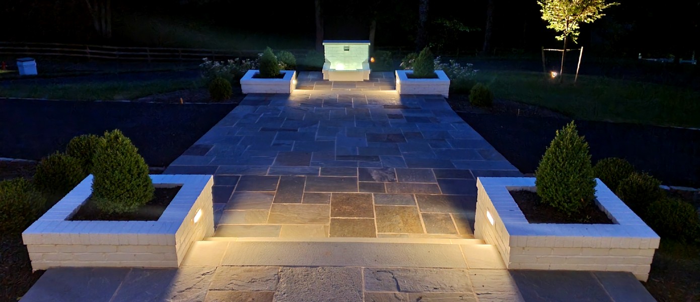 A stone patio with lights

Description automatically generated