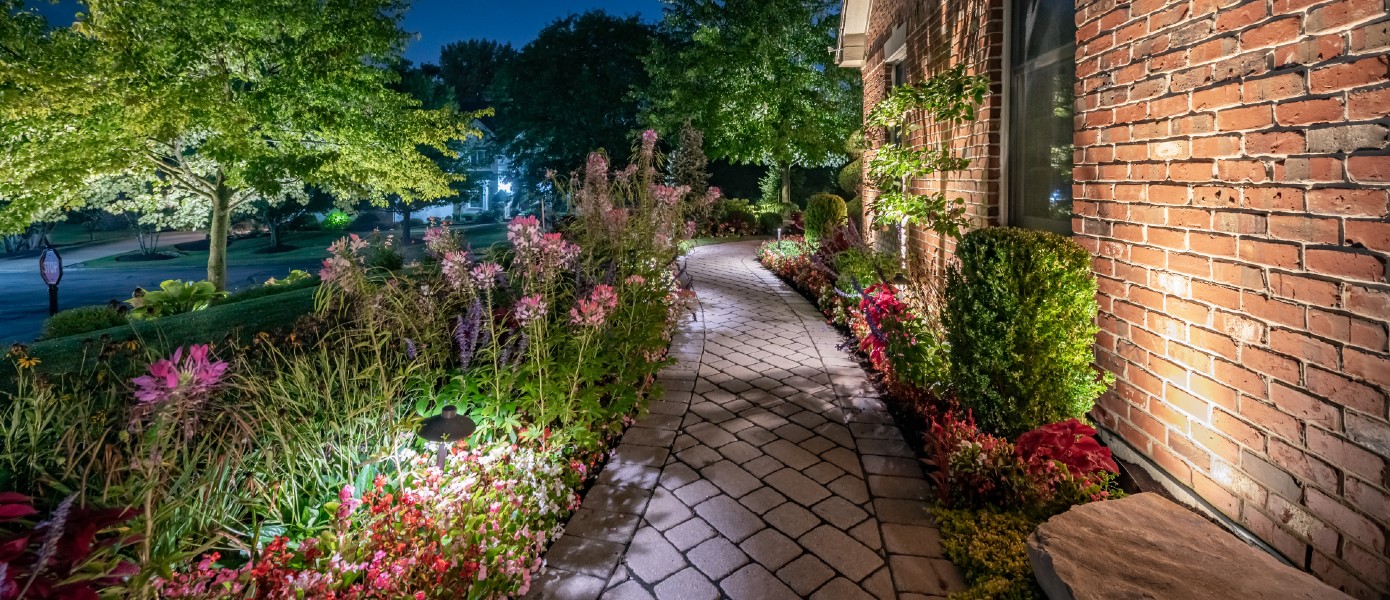 paver walkway with wildflowers and outdoor lighting