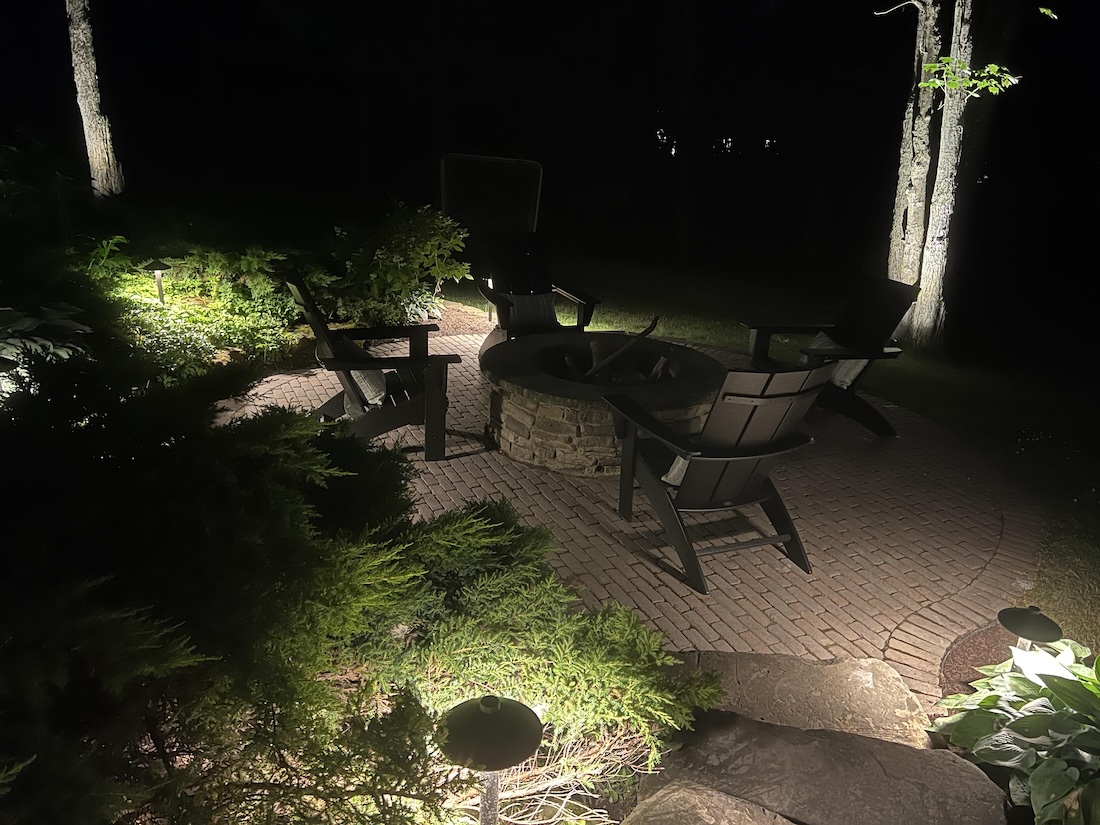 backyard patio with landscape lighting in West Lake OH