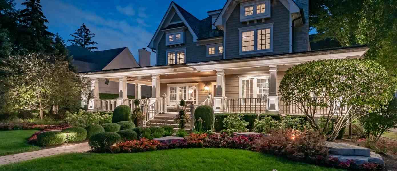 two story house illuminated by outdoor lighting