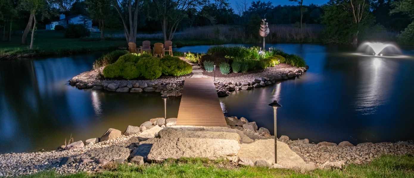 pond with bridge to lighted seating area