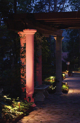 Outdoor pillar lit by red colored lighting lense