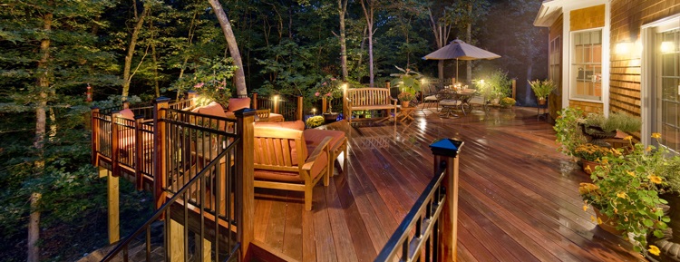 Large deck with seating and a table with an umbrella