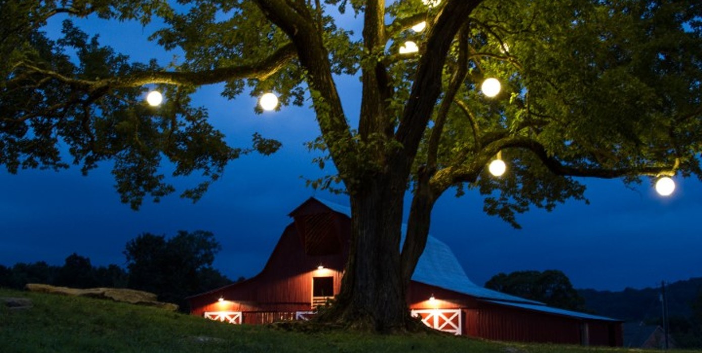 barn with outdoor wedding lighting