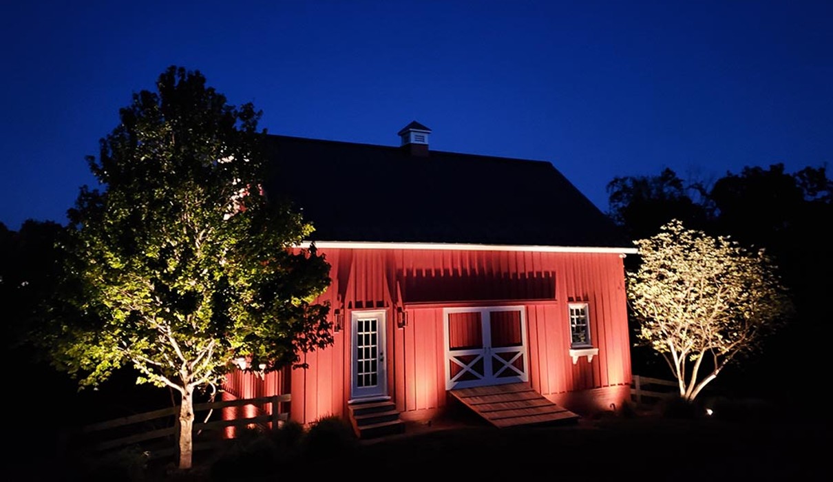 A red barn with trees in front of it