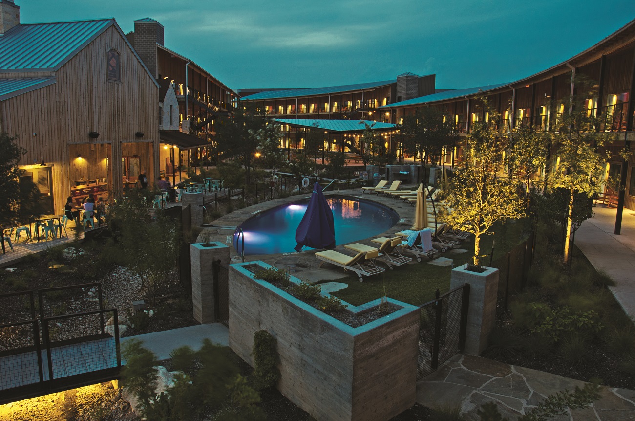 resort with pool, balconies and outdoor lighting