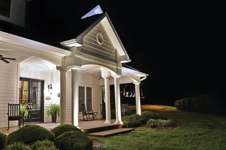 large white house with exterior lights and porch lighting