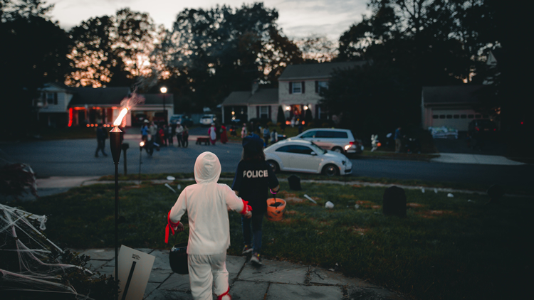 children trick or treating in neighborhood