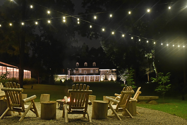 bed and breakfast string lighting over outdoor seating area