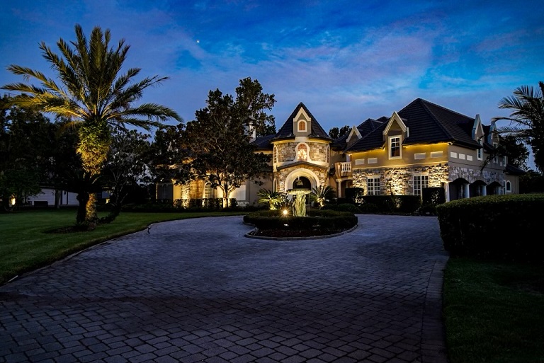 mansion with outdoor lighting