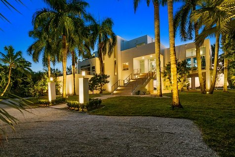 well-lit mansion with palm trees