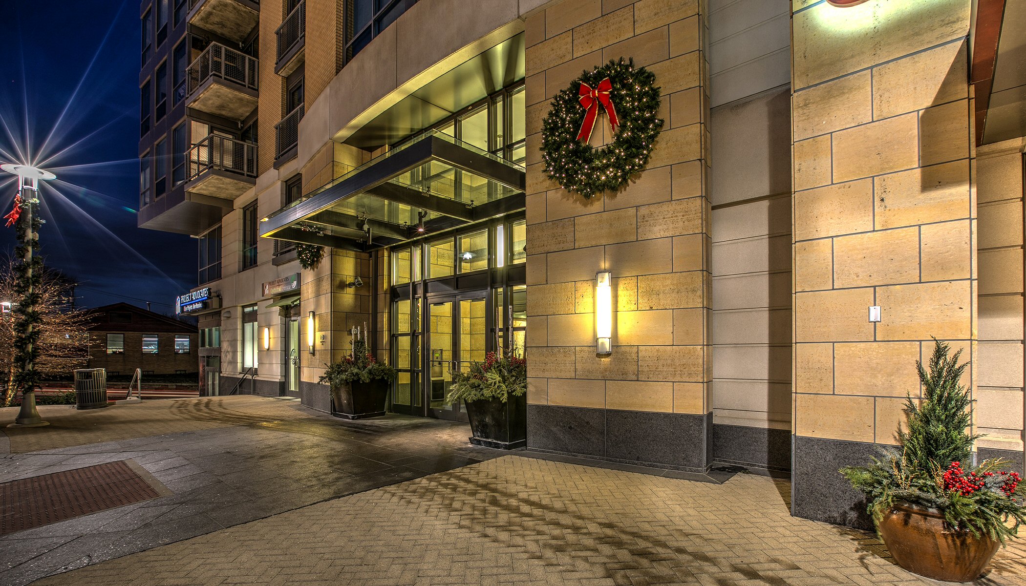 Hotel entrance decorated with Christmas lights and holiday wreaths