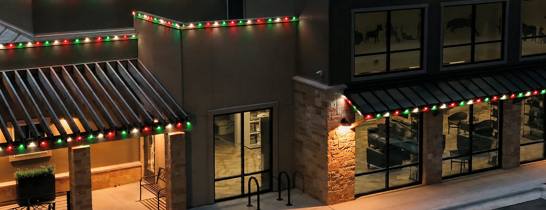 Commercial property decorated with permanent roofline Christmas lights