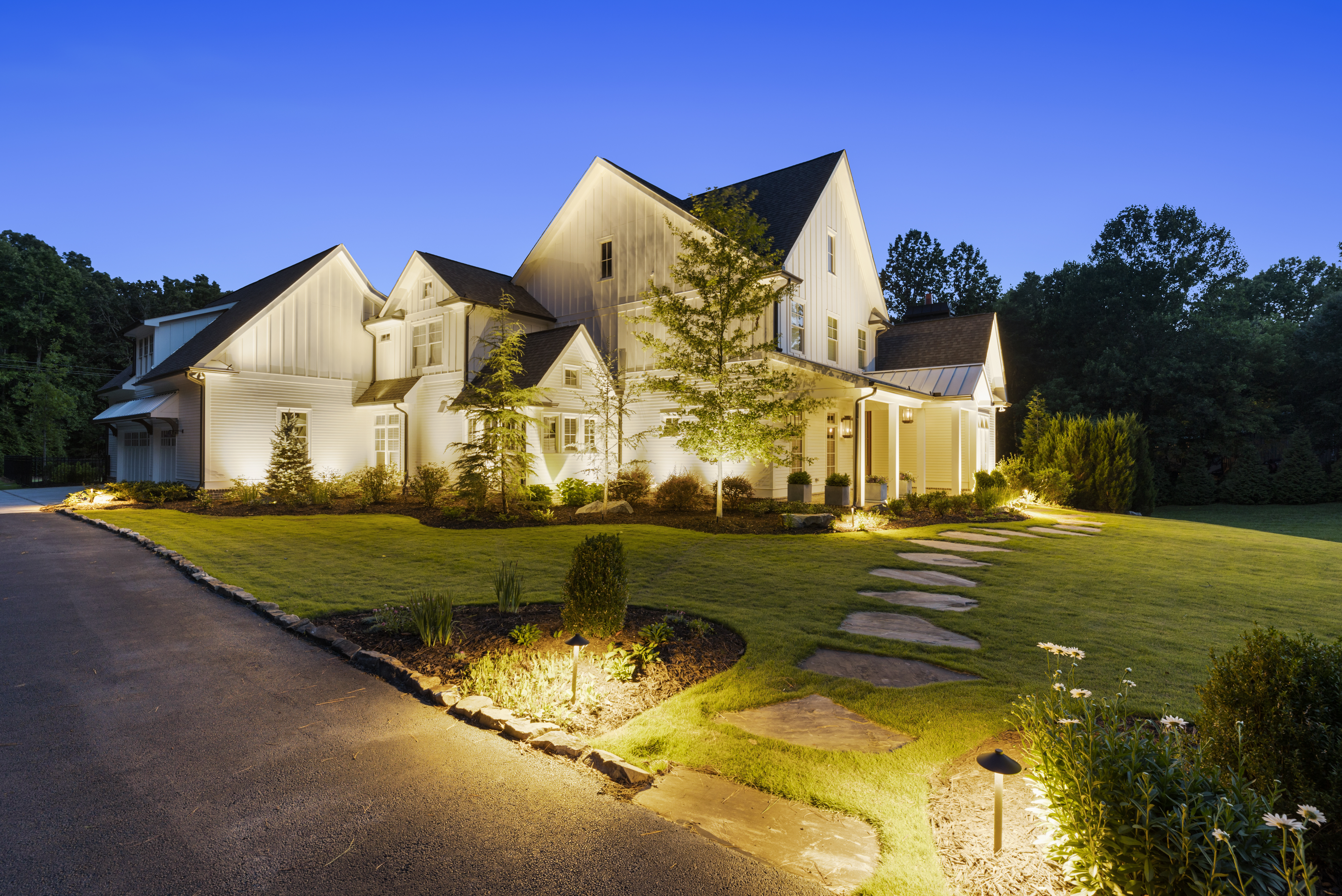 large home with exterior lights and pathway lights
