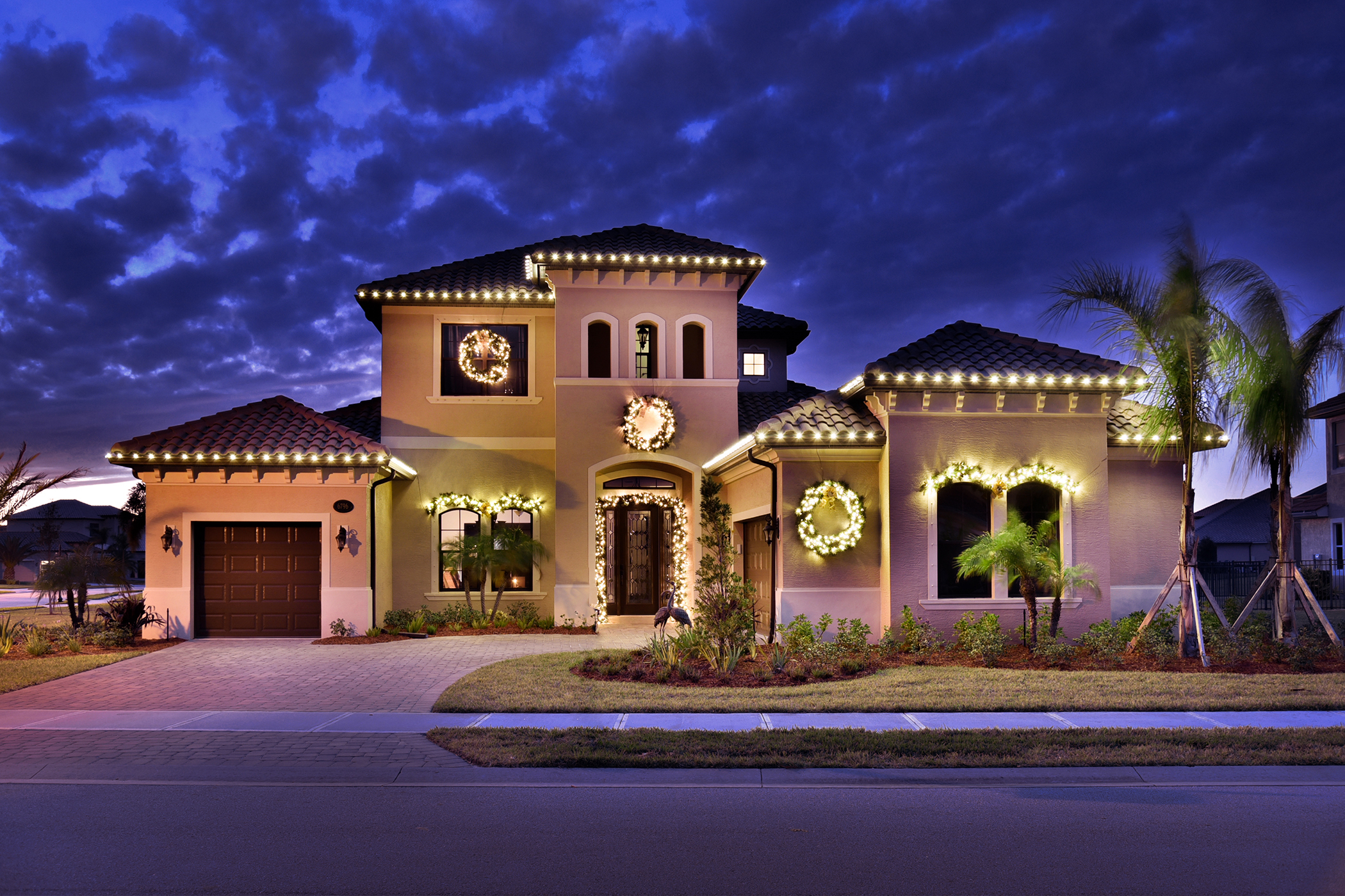 christmas wreaths and lights on house