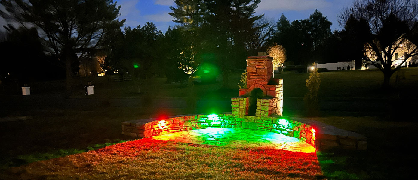 A stone wall with lights on it

Description automatically generated